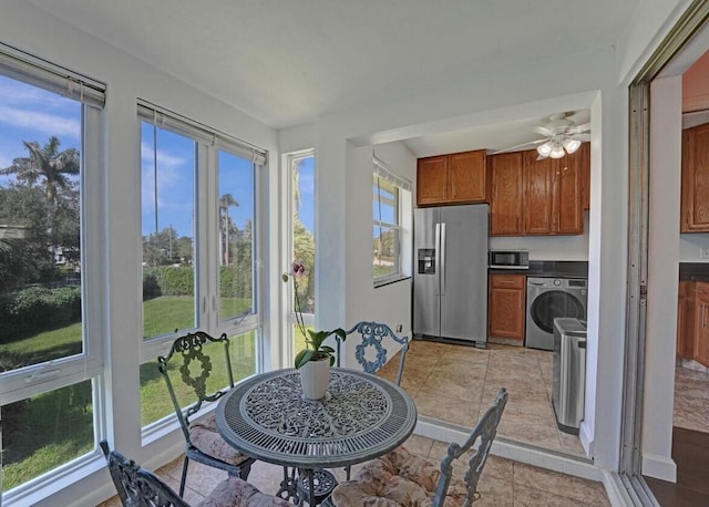 sunroom / solarium with washer / clothes dryer and ceiling fan