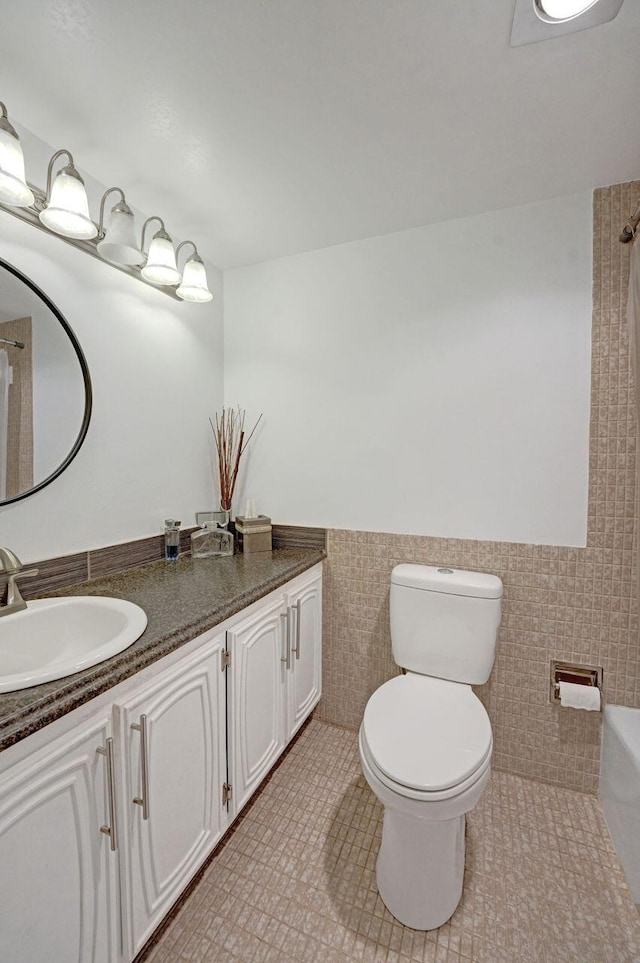 bathroom featuring tile walls, a shower with shower curtain, tile patterned floors, vanity, and toilet