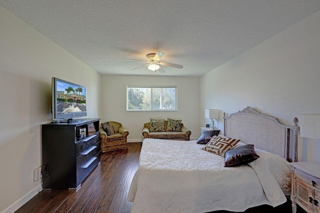 bedroom with a textured ceiling, ceiling fan, and dark hardwood / wood-style flooring