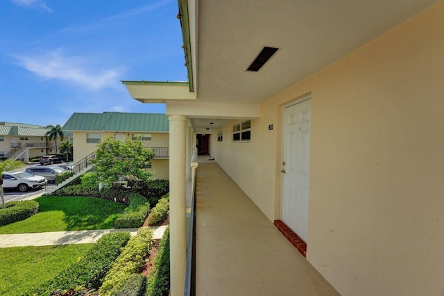 entrance to property featuring a residential view, a balcony, and stucco siding