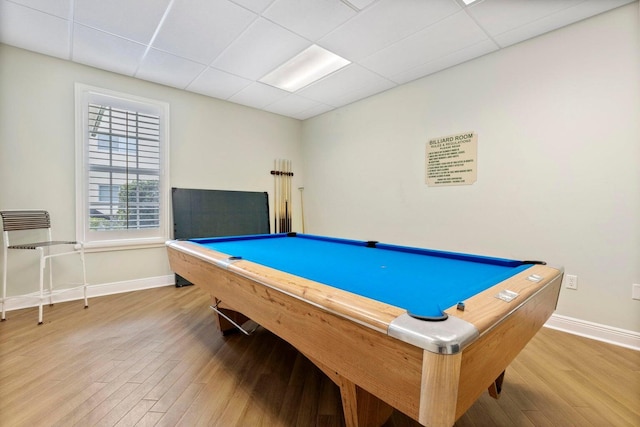 rec room with pool table, a drop ceiling, wood finished floors, and baseboards