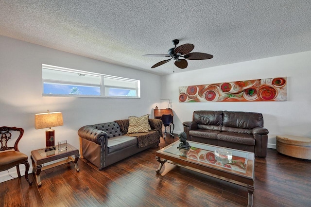 living room featuring a textured ceiling, ceiling fan, and dark wood-type flooring