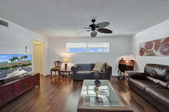 living room featuring ceiling fan, a textured ceiling, and dark hardwood / wood-style floors