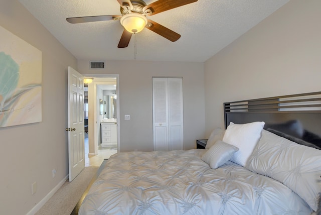 carpeted bedroom featuring a textured ceiling, ceiling fan, and a closet