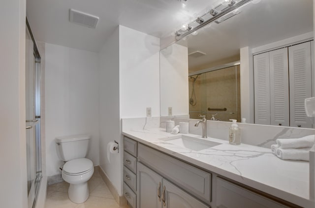 bathroom with vanity, tile patterned floors, and toilet