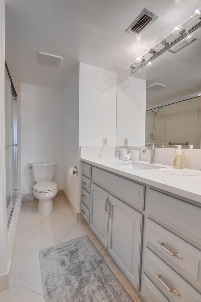 bathroom featuring vanity, tile patterned floors, and toilet