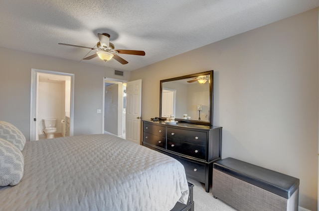 carpeted bedroom featuring connected bathroom, a textured ceiling, and ceiling fan