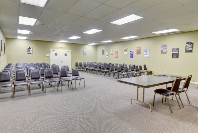 interior space with carpet and a paneled ceiling