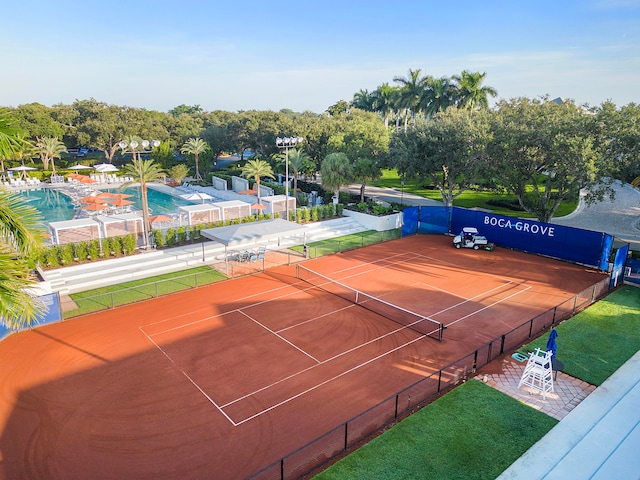 view of tennis court with a community pool