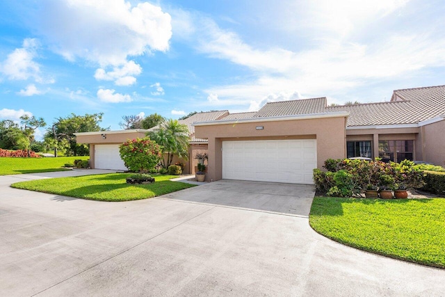 view of front of house with a front yard and a garage