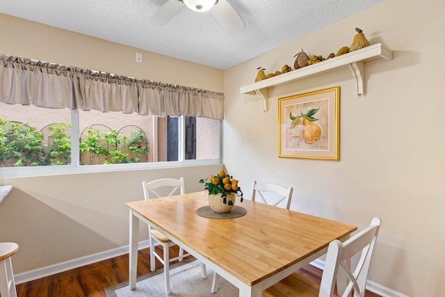 dining area with hardwood / wood-style floors, a textured ceiling, ceiling fan, and a wealth of natural light