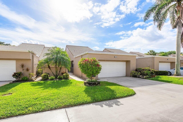 view of front of home featuring a front yard and a garage