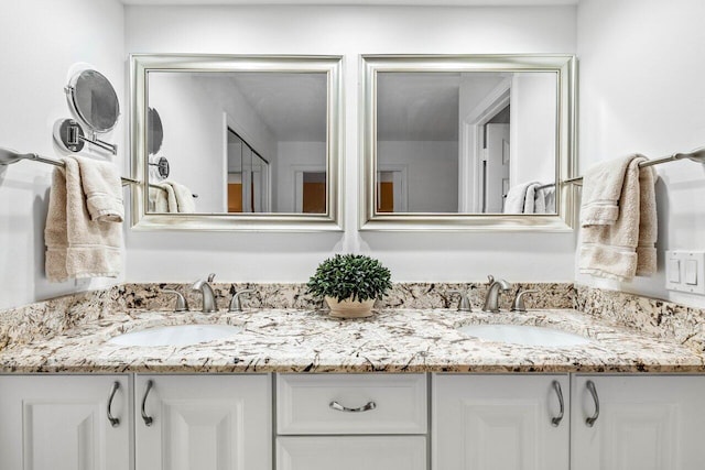 bathroom featuring dual sinks and oversized vanity