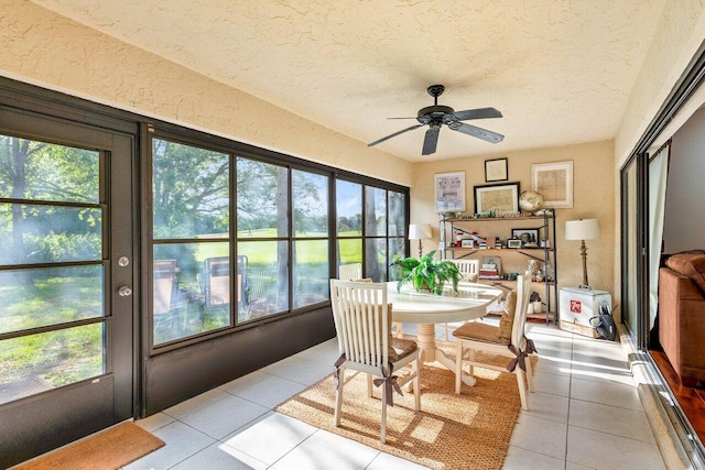 sunroom / solarium featuring ceiling fan