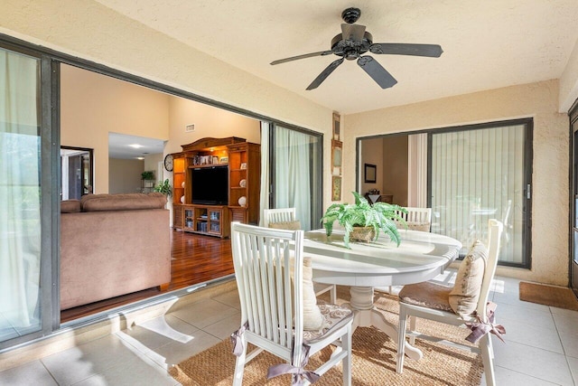 dining room with light tile floors and ceiling fan