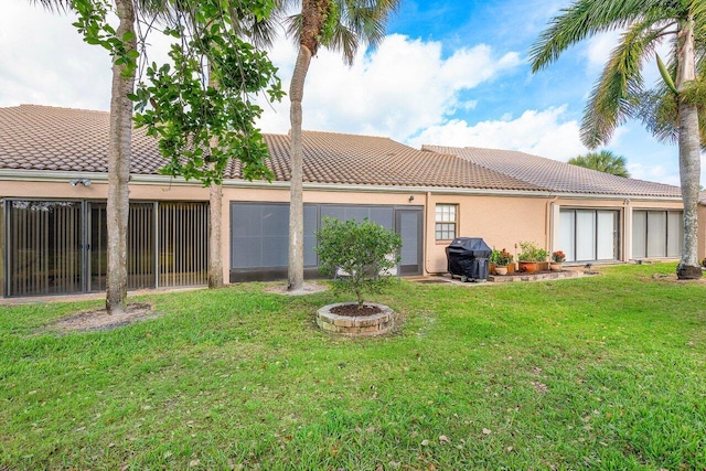 rear view of property with a yard