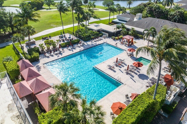 view of pool with a lawn and a patio