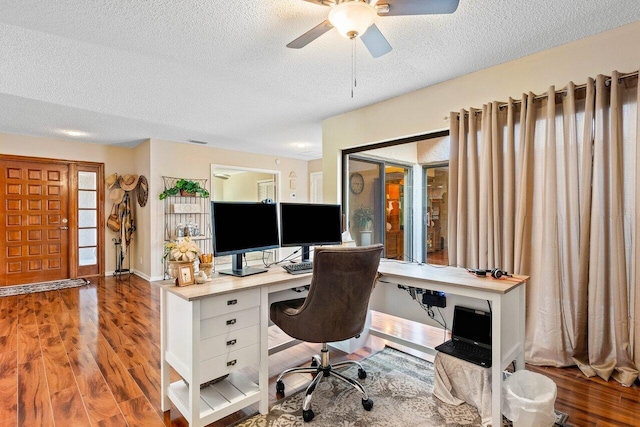 office with a textured ceiling, ceiling fan, and dark hardwood / wood-style floors