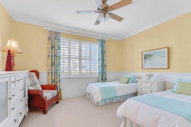 bedroom with light colored carpet, ceiling fan, and crown molding