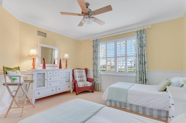 bedroom featuring light carpet, ceiling fan, and crown molding