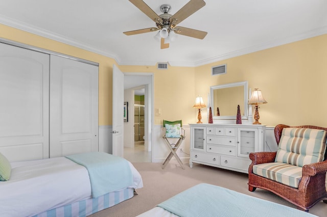 bedroom featuring a closet, ornamental molding, and ceiling fan