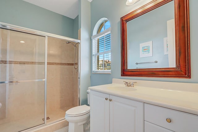 bathroom featuring vanity, toilet, and walk in shower