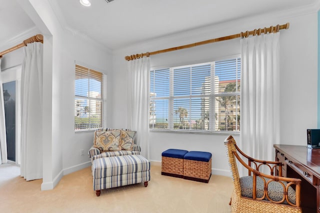 sitting room featuring light colored carpet and ornamental molding