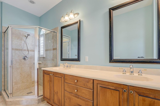 bathroom featuring tile patterned floors, vanity, and a shower with door