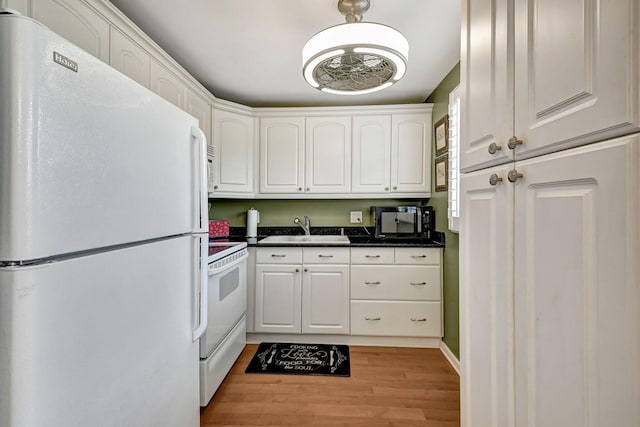 kitchen with white cabinets, white appliances, sink, and light wood-type flooring