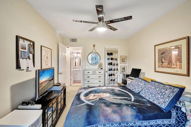 bedroom with connected bathroom, carpet flooring, and ceiling fan