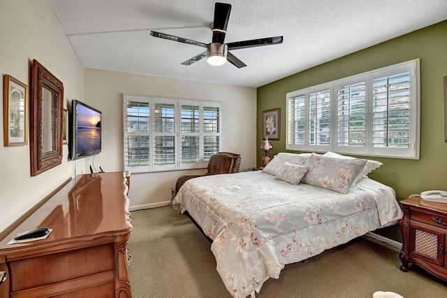 bedroom featuring carpet flooring, a textured ceiling, and ceiling fan