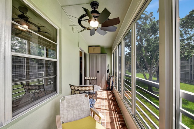 sunroom / solarium featuring ceiling fan and plenty of natural light