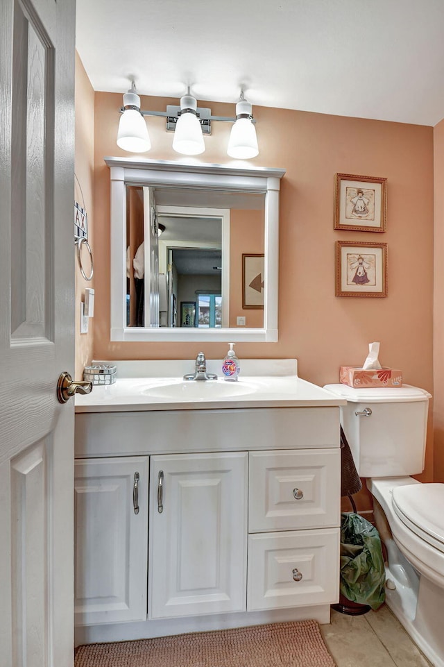 bathroom featuring toilet, vanity, and tile patterned floors