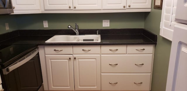 kitchen featuring range with electric stovetop, white cabinetry, sink, and dishwashing machine