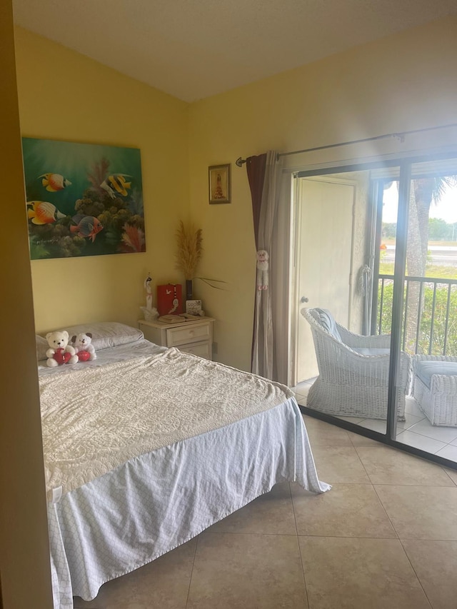 tiled bedroom featuring lofted ceiling and access to outside