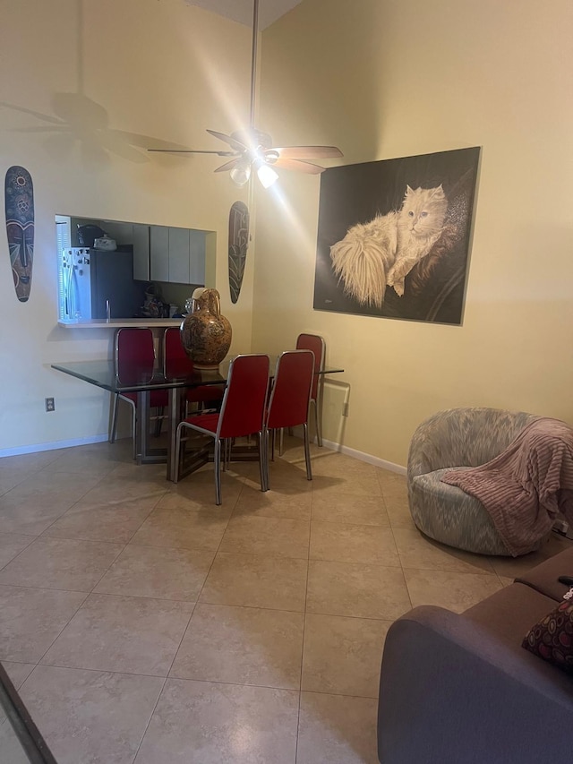 dining room with light tile floors, lofted ceiling, and ceiling fan