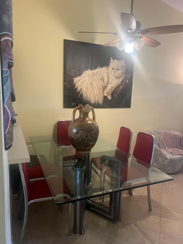 dining space with light tile flooring and ceiling fan