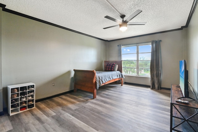 bedroom with ceiling fan, a textured ceiling, and dark hardwood / wood-style flooring