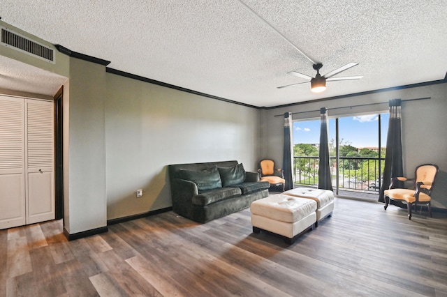 living room featuring a textured ceiling, ceiling fan, and dark hardwood / wood-style floors