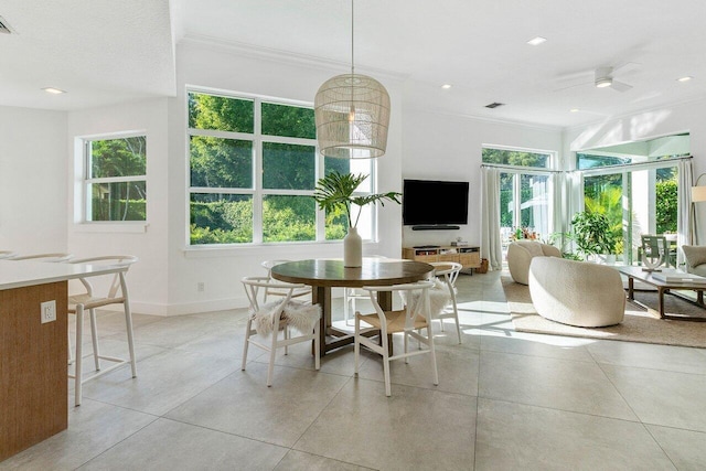 dining space featuring ornamental molding, a healthy amount of sunlight, ceiling fan, and light tile floors