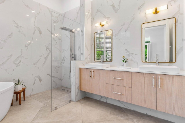 bathroom featuring tile walls, dual bowl vanity, tile flooring, and independent shower and bath