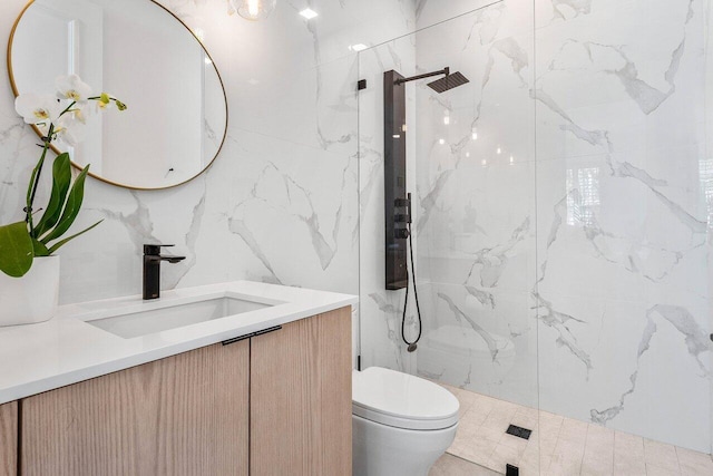 bathroom featuring tile walls, vanity, toilet, and tiled shower