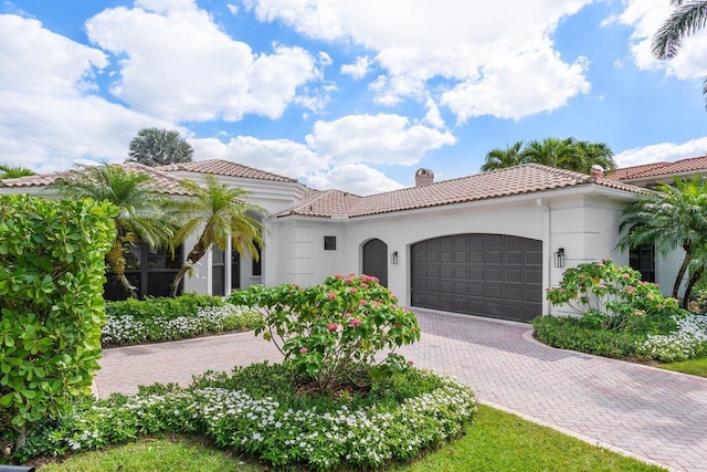 mediterranean / spanish home with a garage