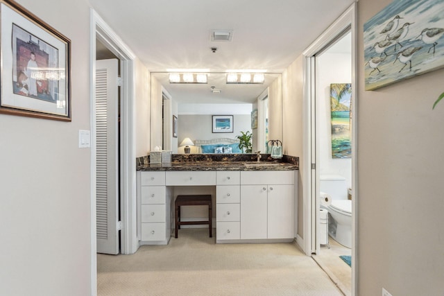 bathroom featuring toilet and vanity