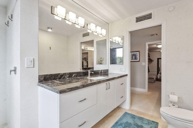 bathroom with toilet and vanity