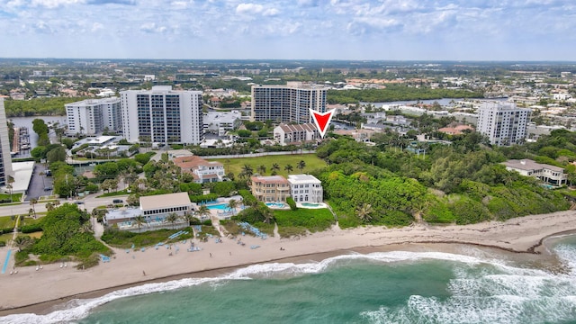 birds eye view of property with a beach view and a water view