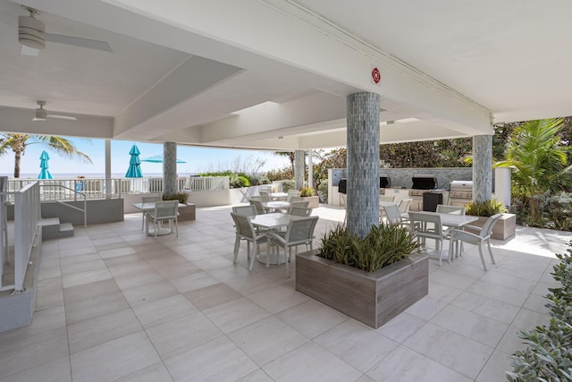 view of terrace with ceiling fan, an outdoor kitchen, and area for grilling