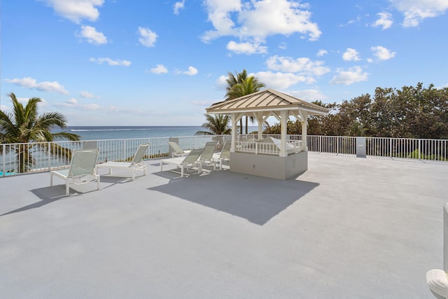 view of patio / terrace featuring a gazebo and a water view