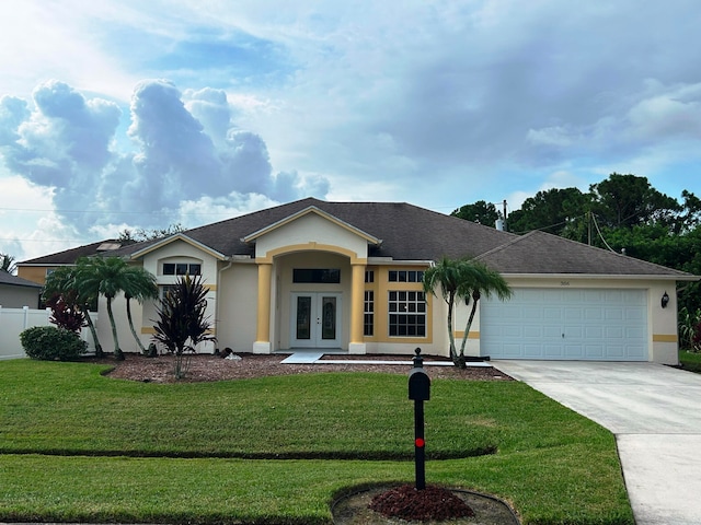 ranch-style house with french doors, a garage, and a front lawn