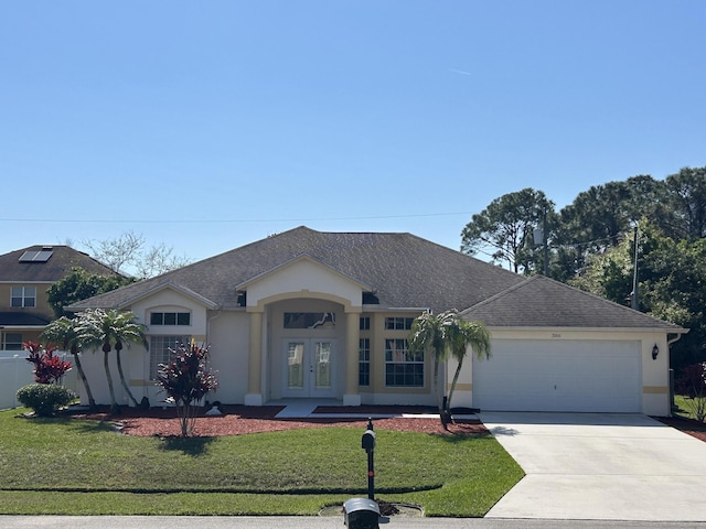 single story home featuring a garage, driveway, french doors, stucco siding, and a front lawn